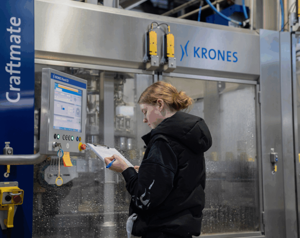 Brewery technician monitoring beer production using a digital Krones control system at bStudio.